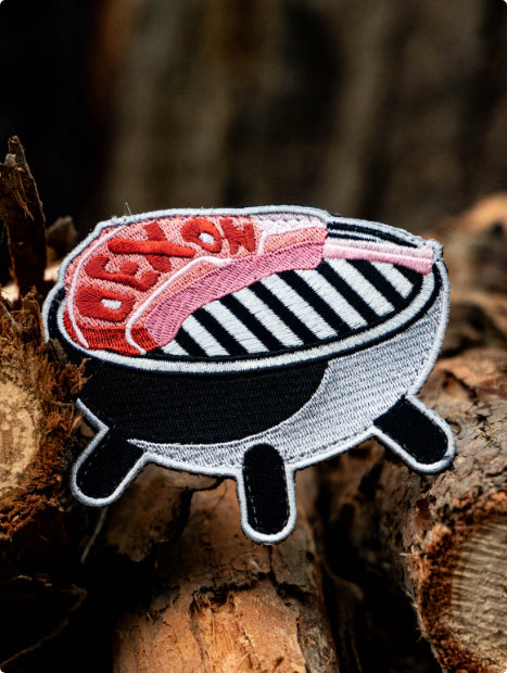 An embroidered patch shaped like a BBQ grill